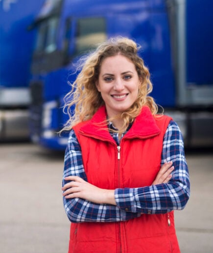 Driver standing in front of her truck